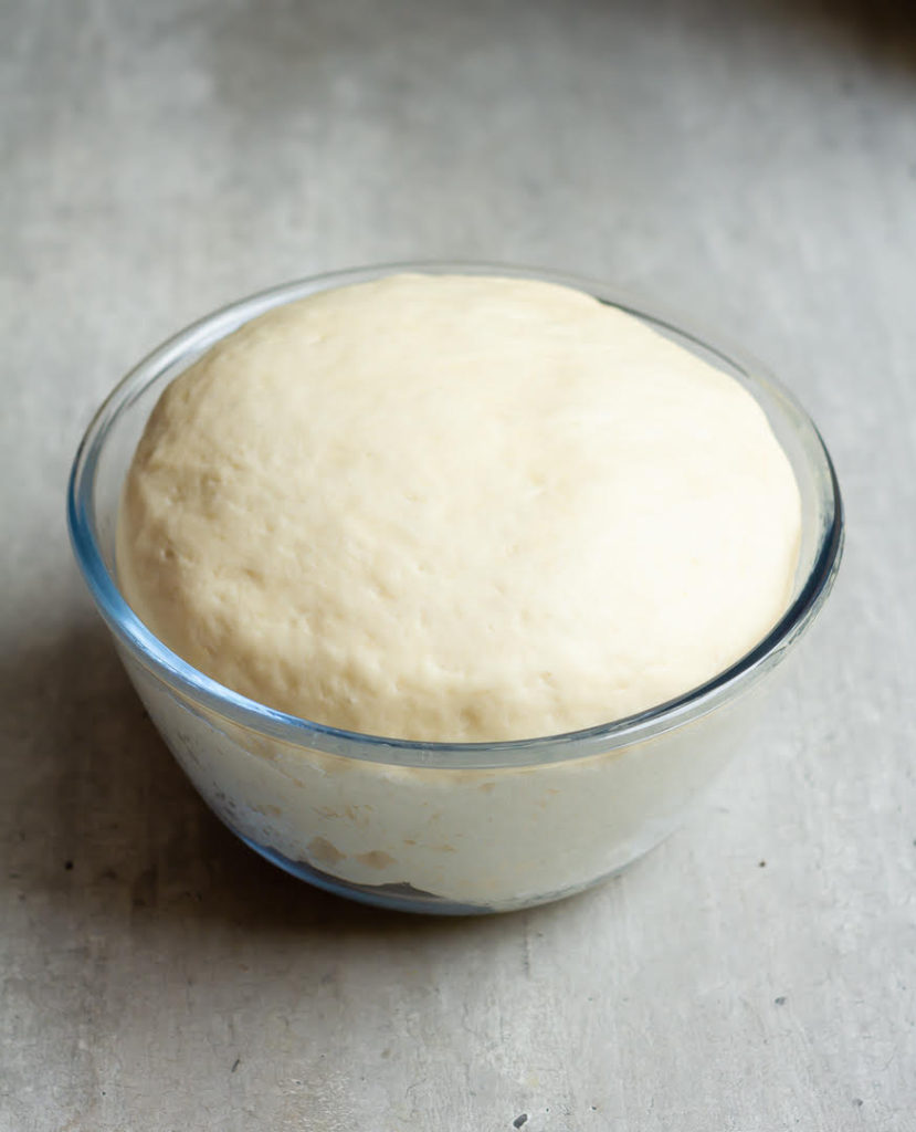 Dough for mango-filled donuts in a mixing bowl.