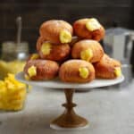 mango-filled donuts on a cake stand.