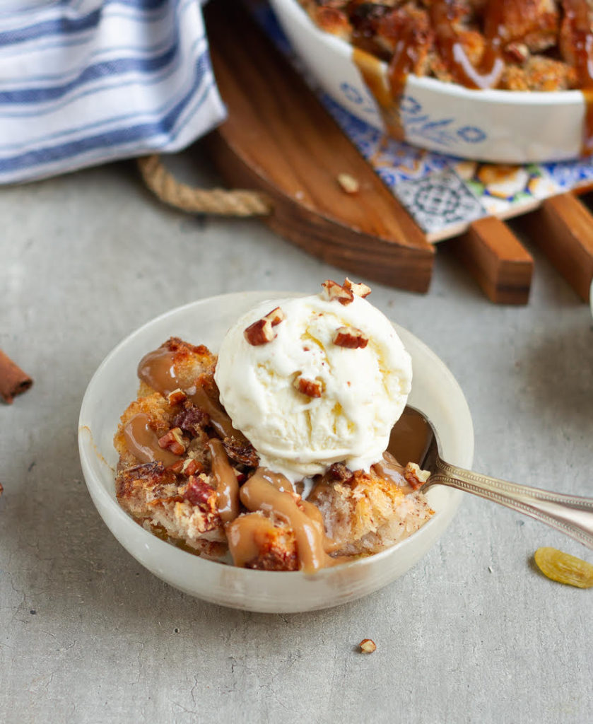 Cinnamon bread pudding with ice cream in a bowl.