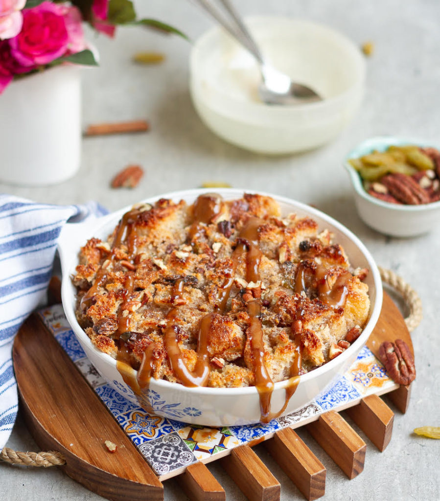 bread pudding in a baking dish with caramel on top.