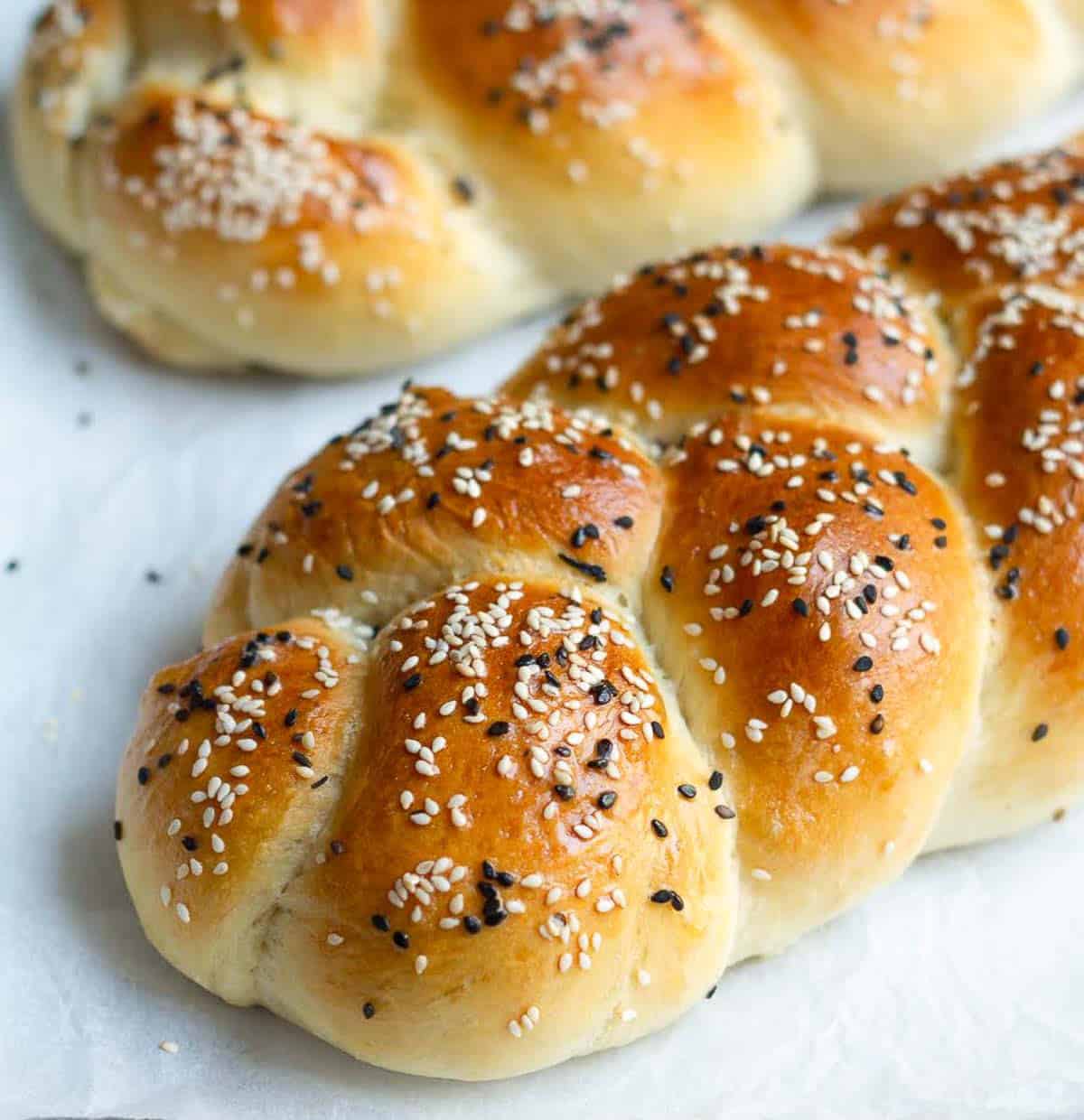 A braided bread on parchment paper.