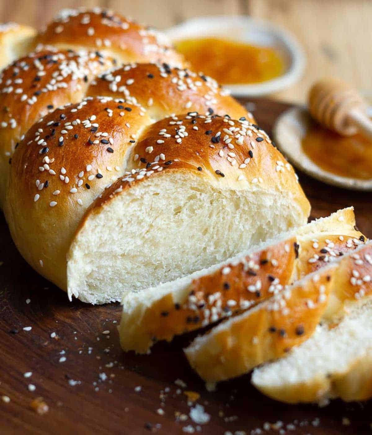 Sliced bread with seeds on a wooden board.