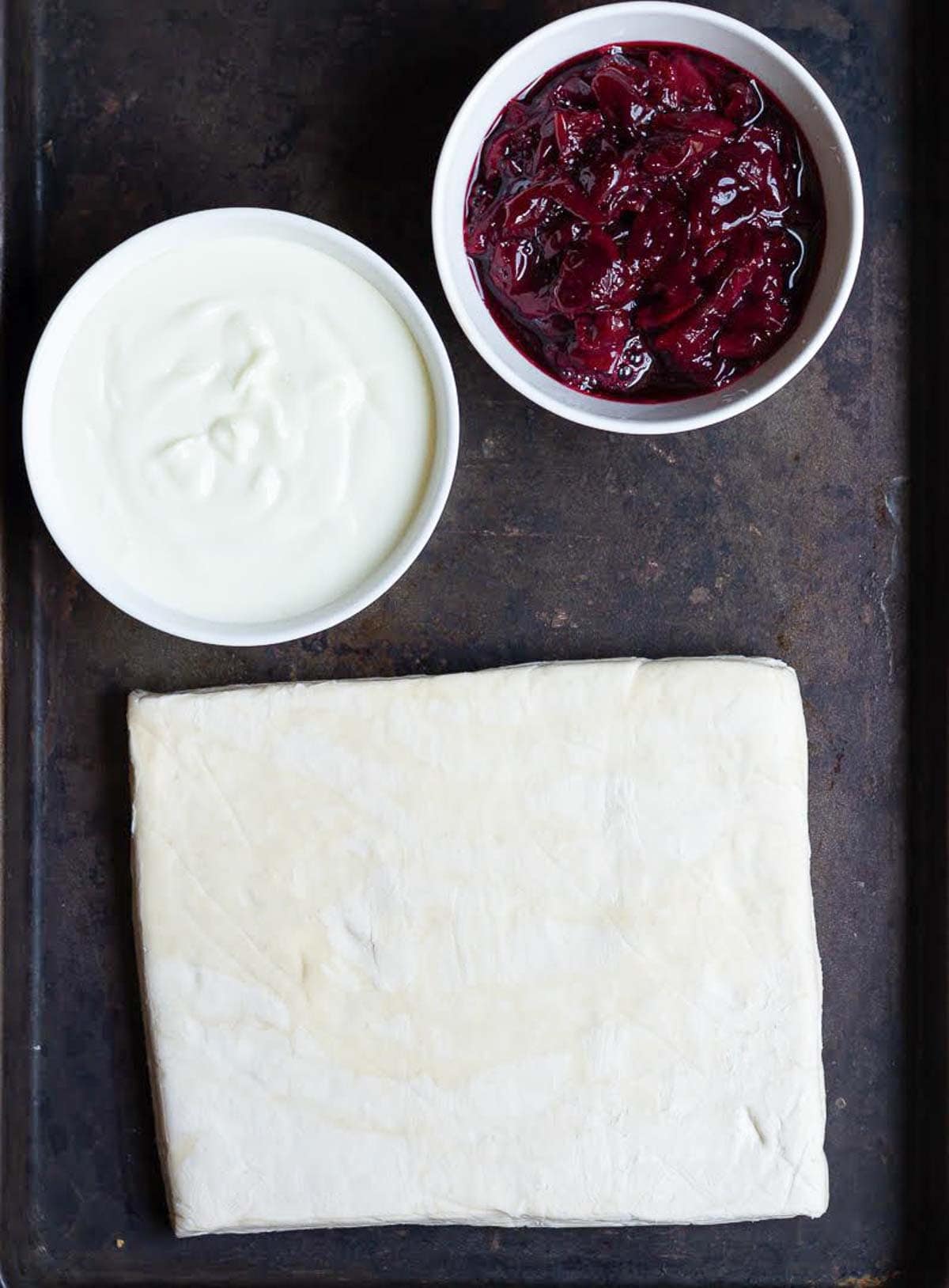 Cream cheese, puff pastry, cherry compote, ingredients for making cherry puff pastry.