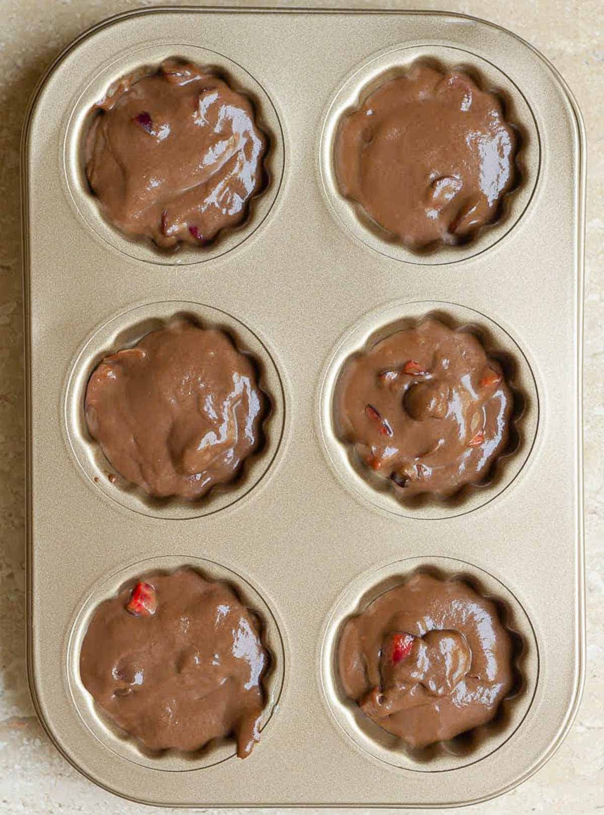 Madeleine batter in a madeleine mold.