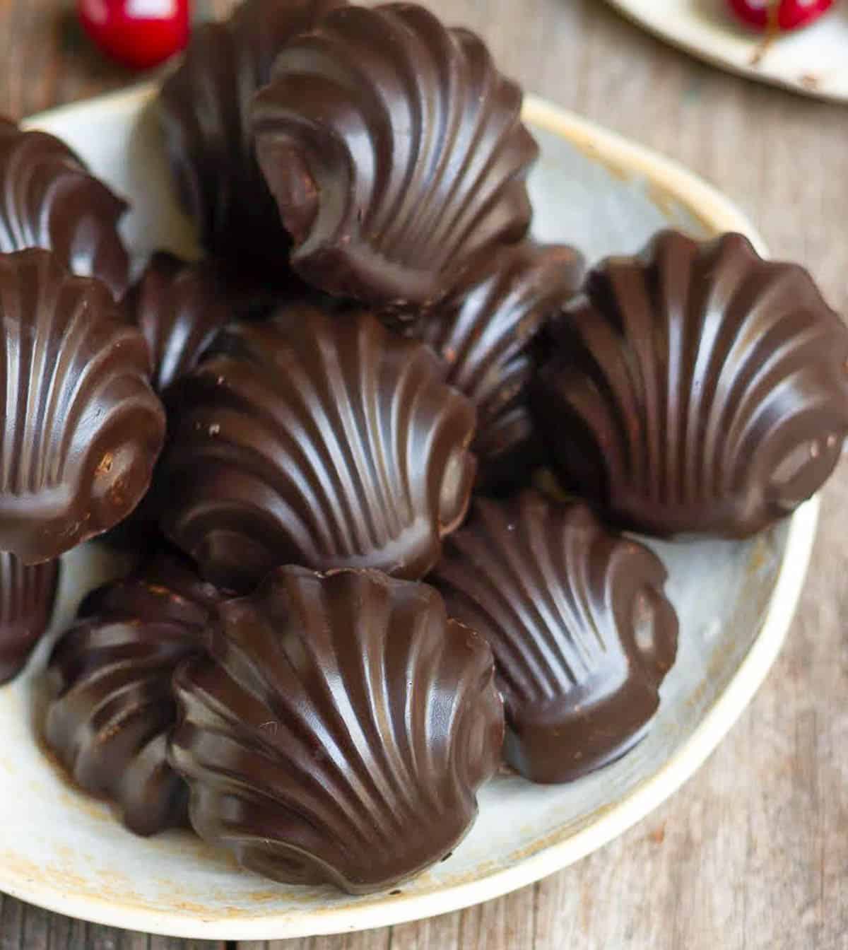 A plateful of chocolate dipped madeleines.