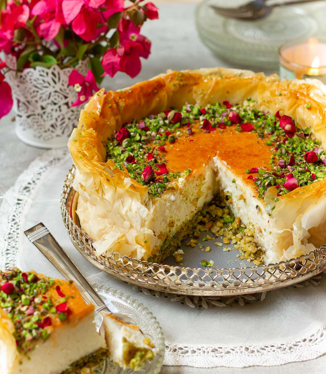 Baklava cheesecake with a slice taken out to show the cross-section.
