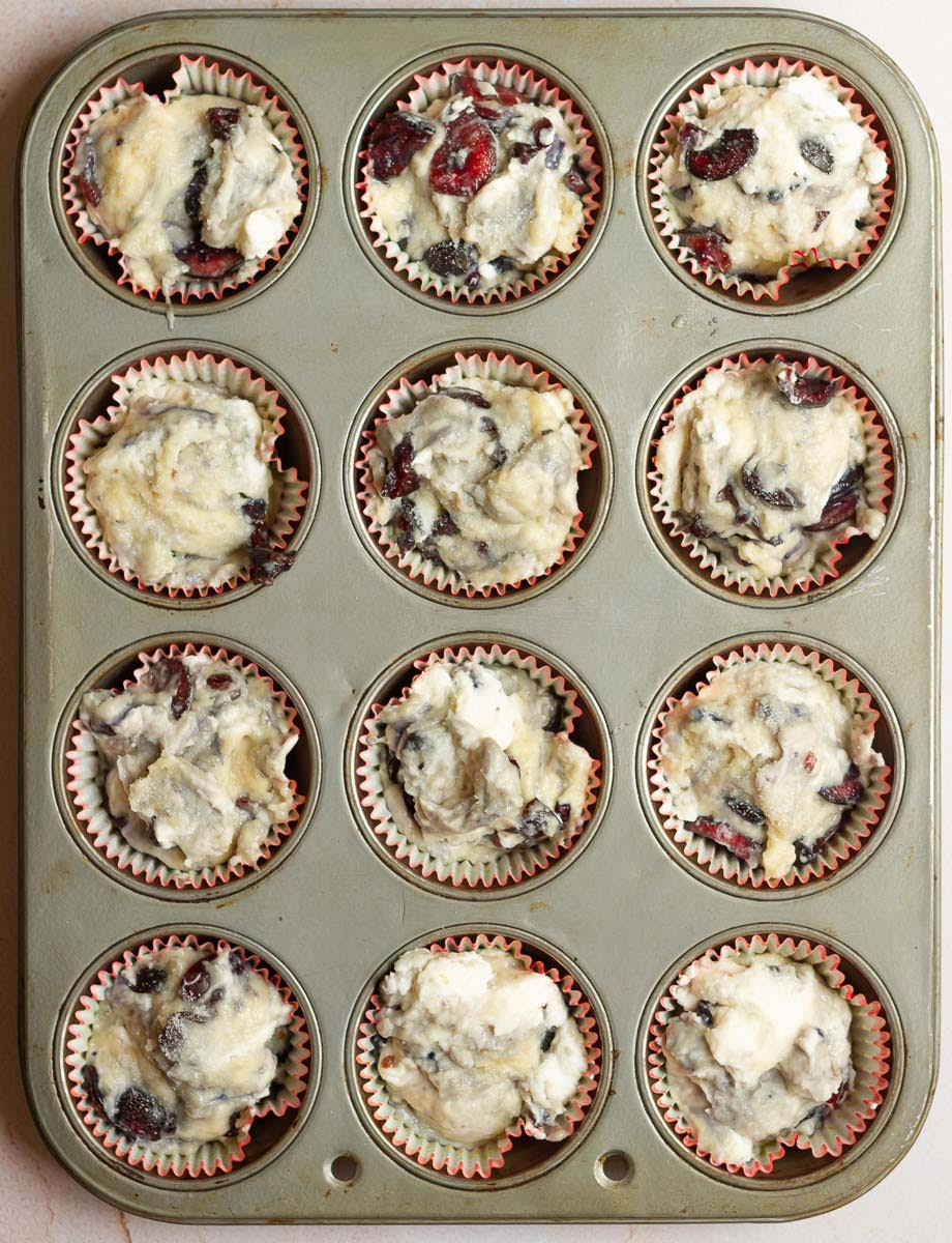 Muffin batter in a muffin tray.
