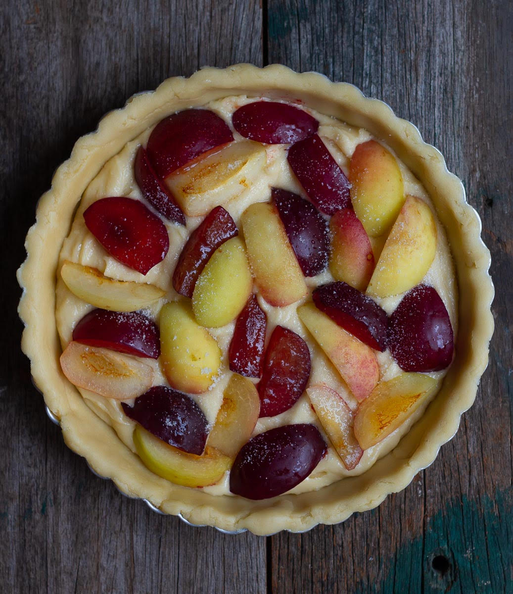 Place sliced plums and apricots on top and bake
