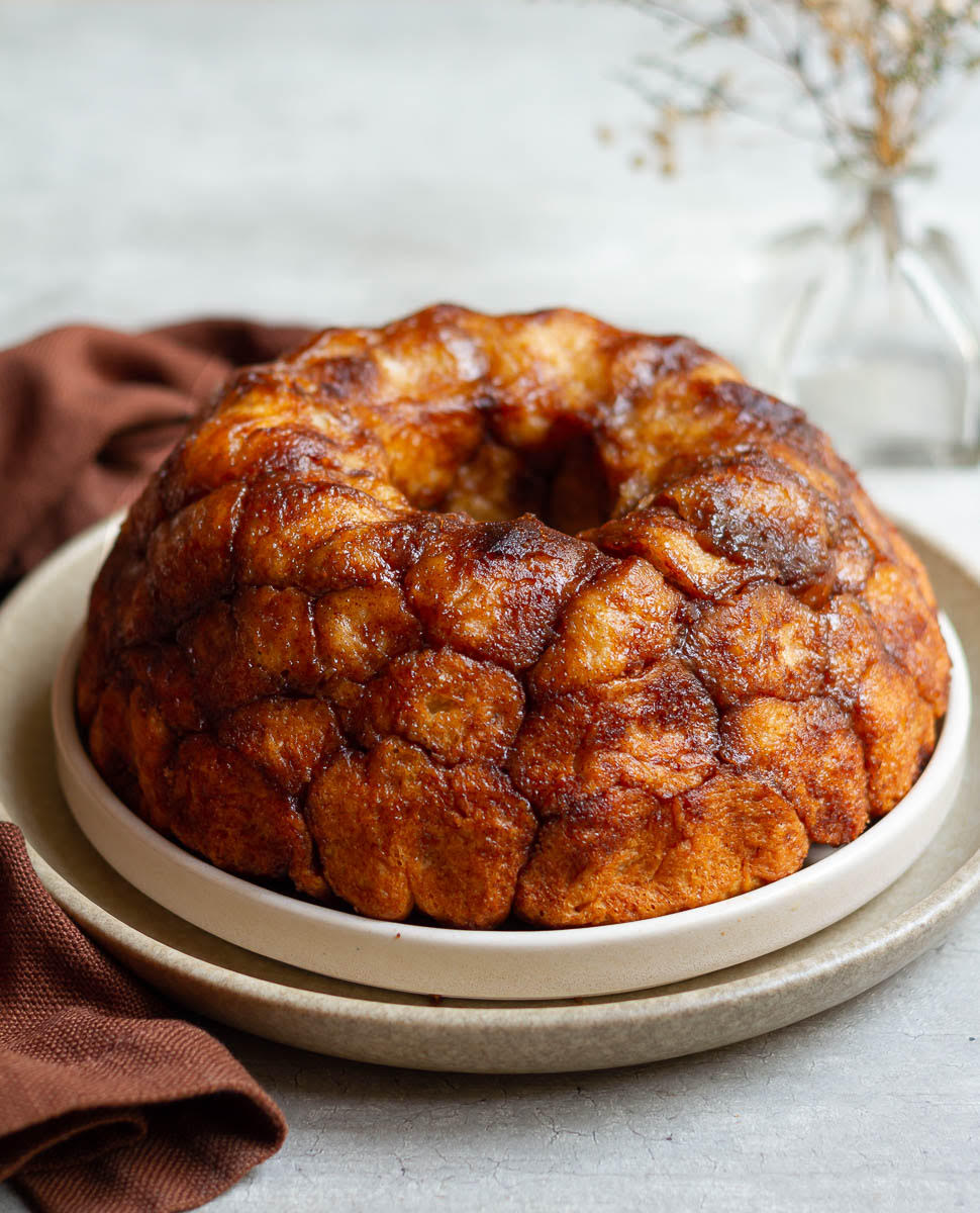 Monkey bread on 2 serving platters with a brown napkin next to it.