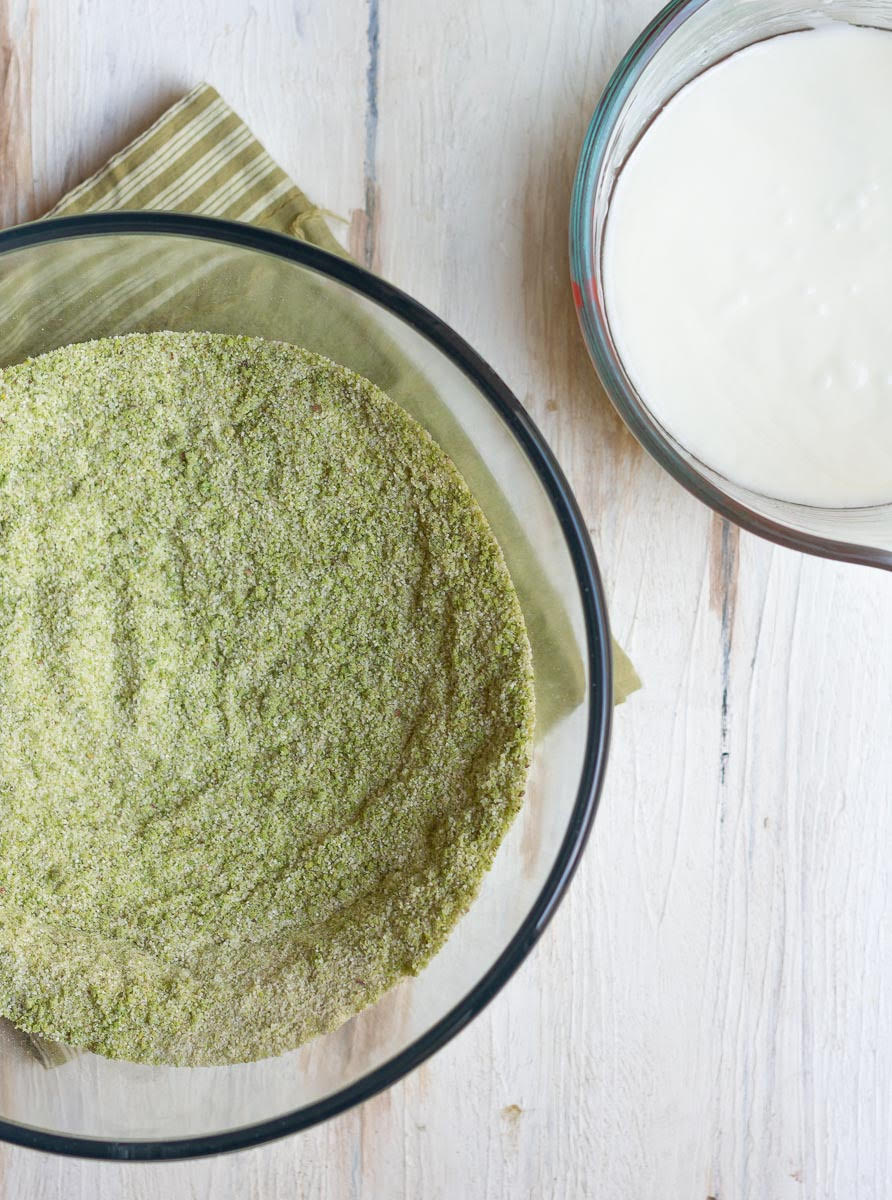 Dry and wet ingredients for cake in mixing bowls.