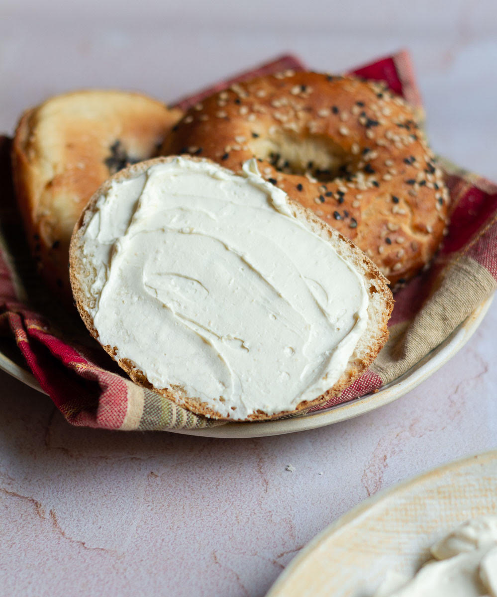 cream cheese smeared on half a bagel.