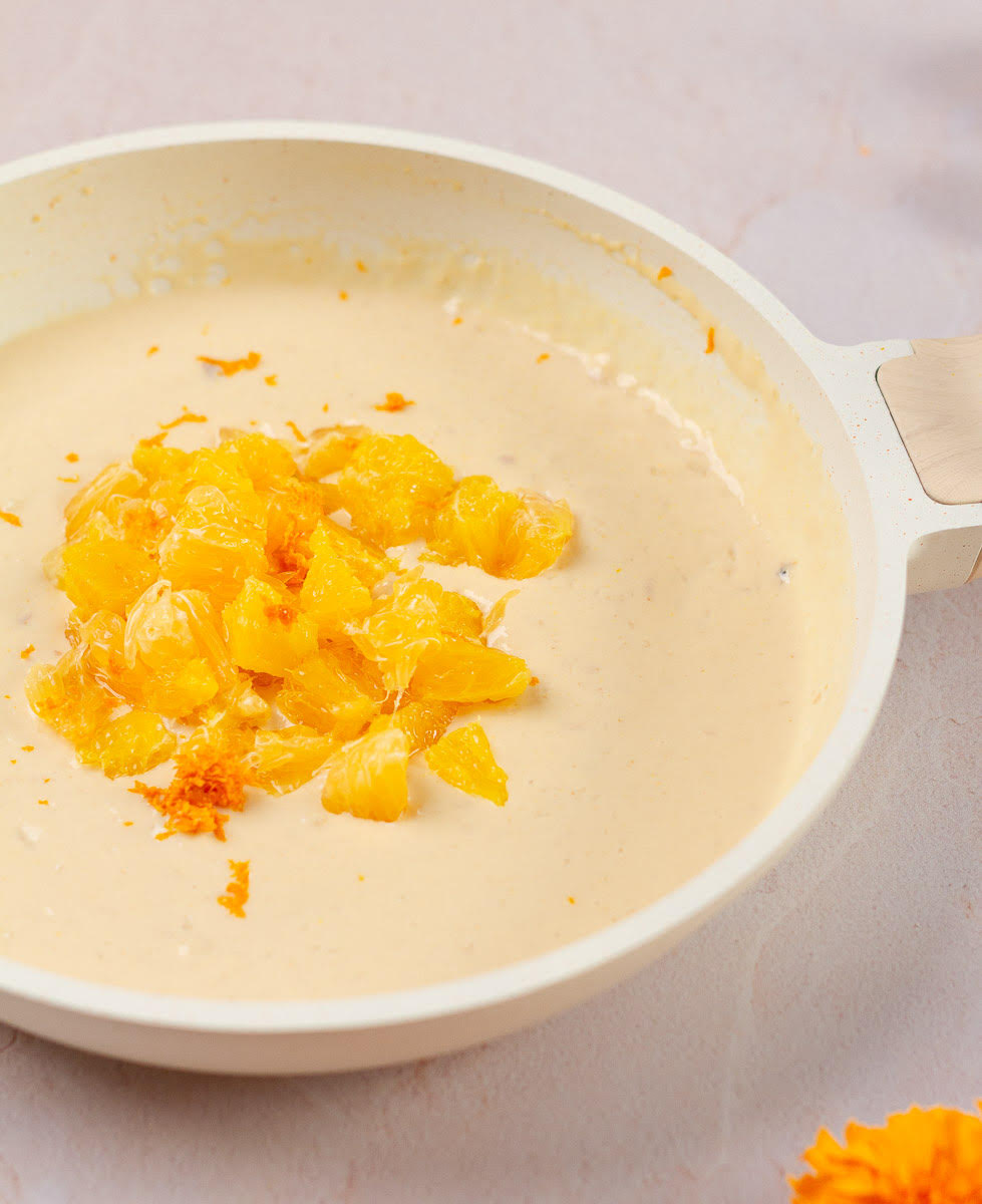 Add orange segments nad zest to the chilled milk