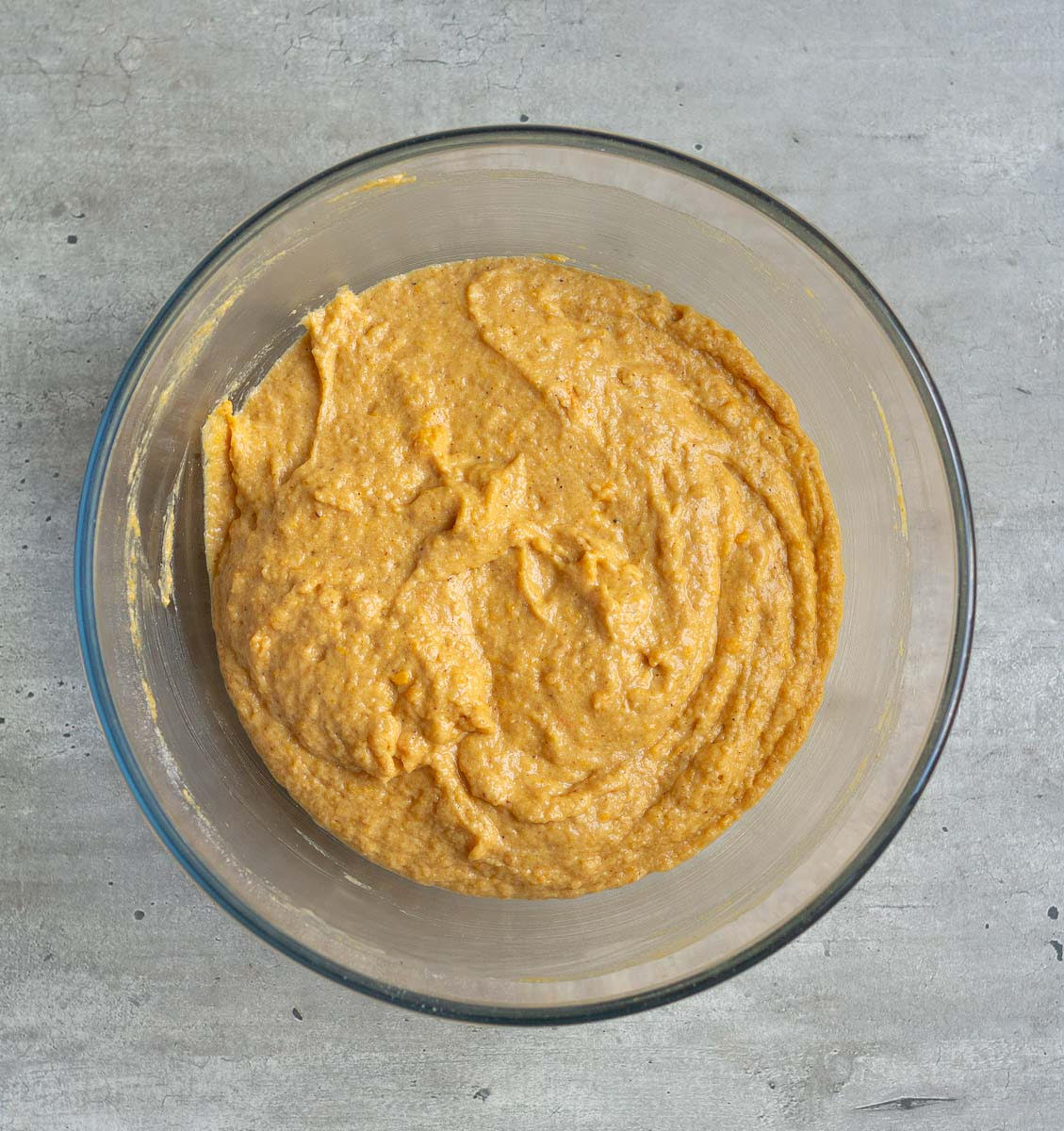 Batter for pumpkin muffins in a mixing bowl.
