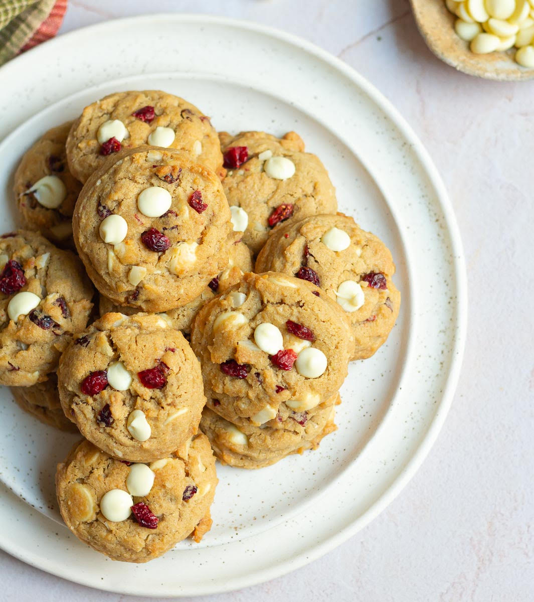 Cookies with white chocolate and cranberries on a plate.