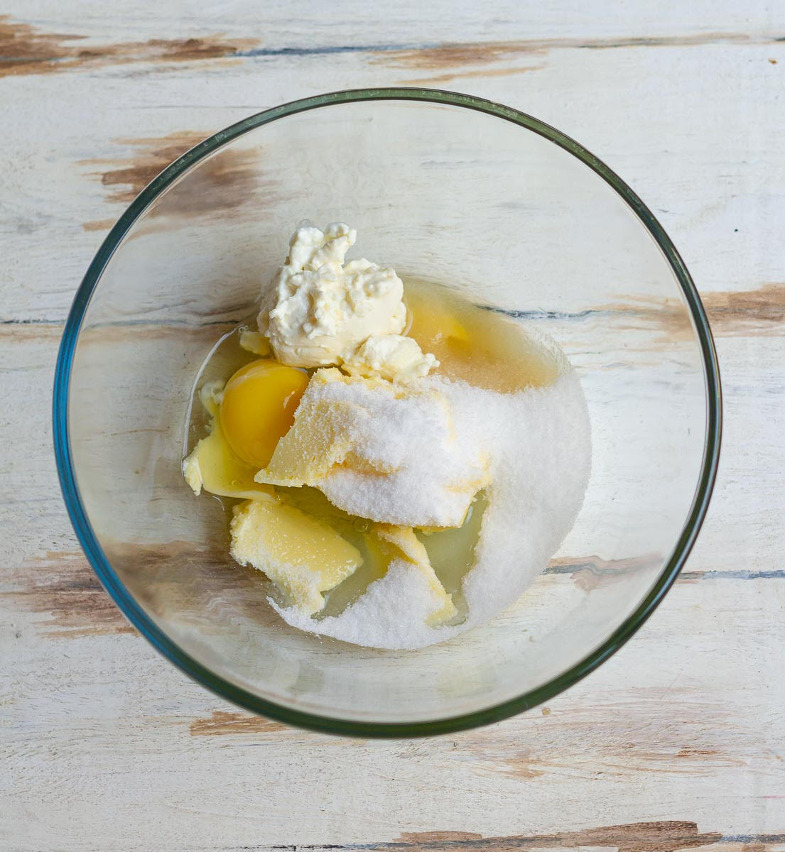 Egg, butter, cream cheese and sugar in a mixing bowl.