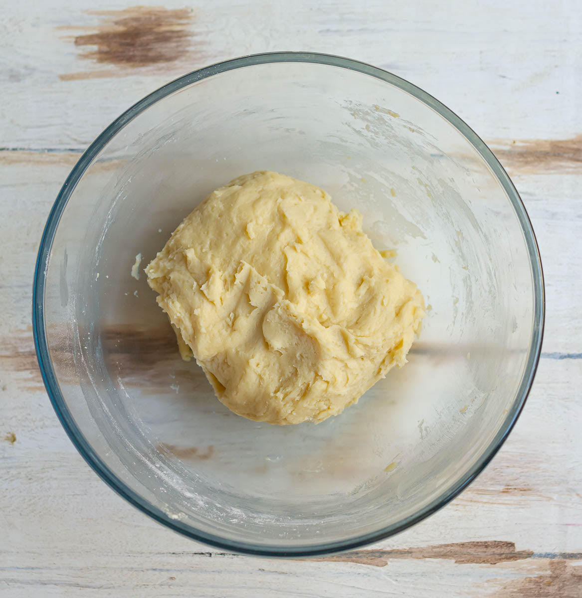 Cookie dough in a glass mixing bowl.