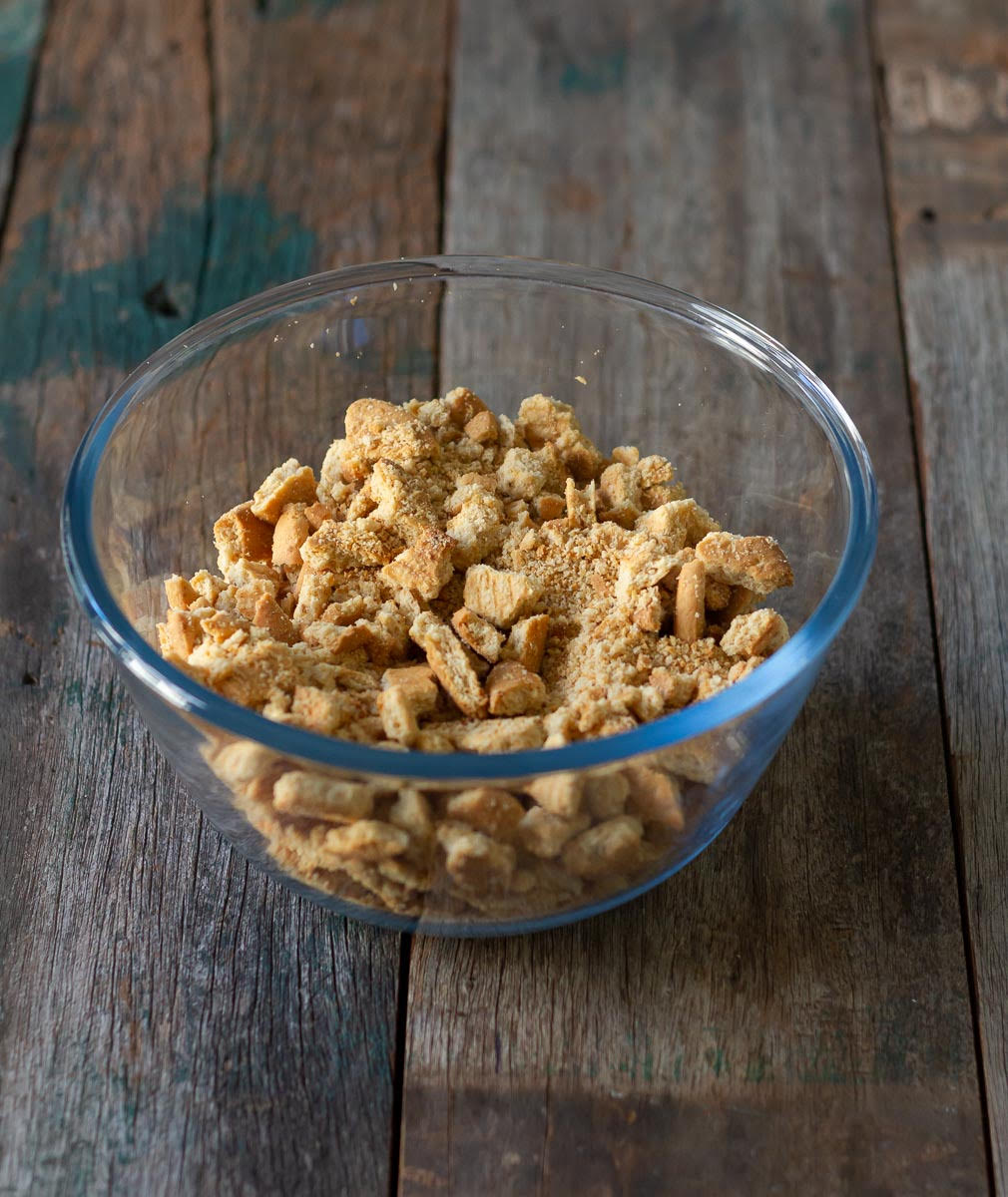 Crushed digestive biscuits in a small bowl.
