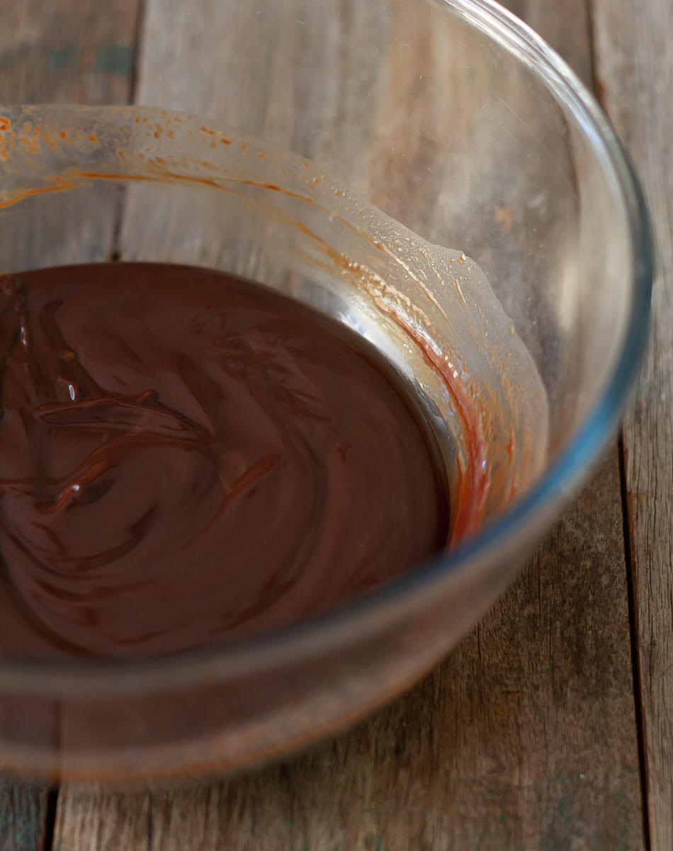 Melted chocolate, butter, and milk in a mixing bowl.
