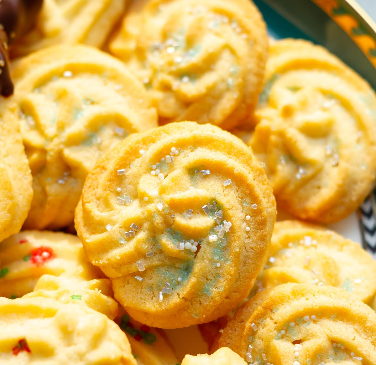 Spritz cookies with white and blue colored sugar decoration.