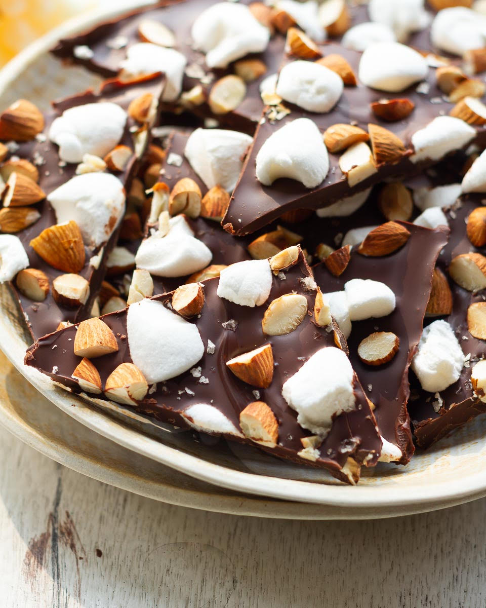 Chocolate bark broken into pieces on a plate.