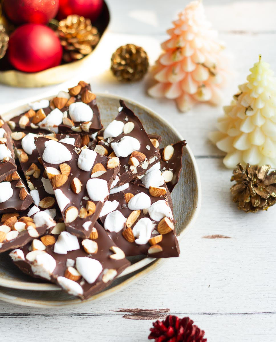 Chocolate bark with almonds and marshmallows on a plate.