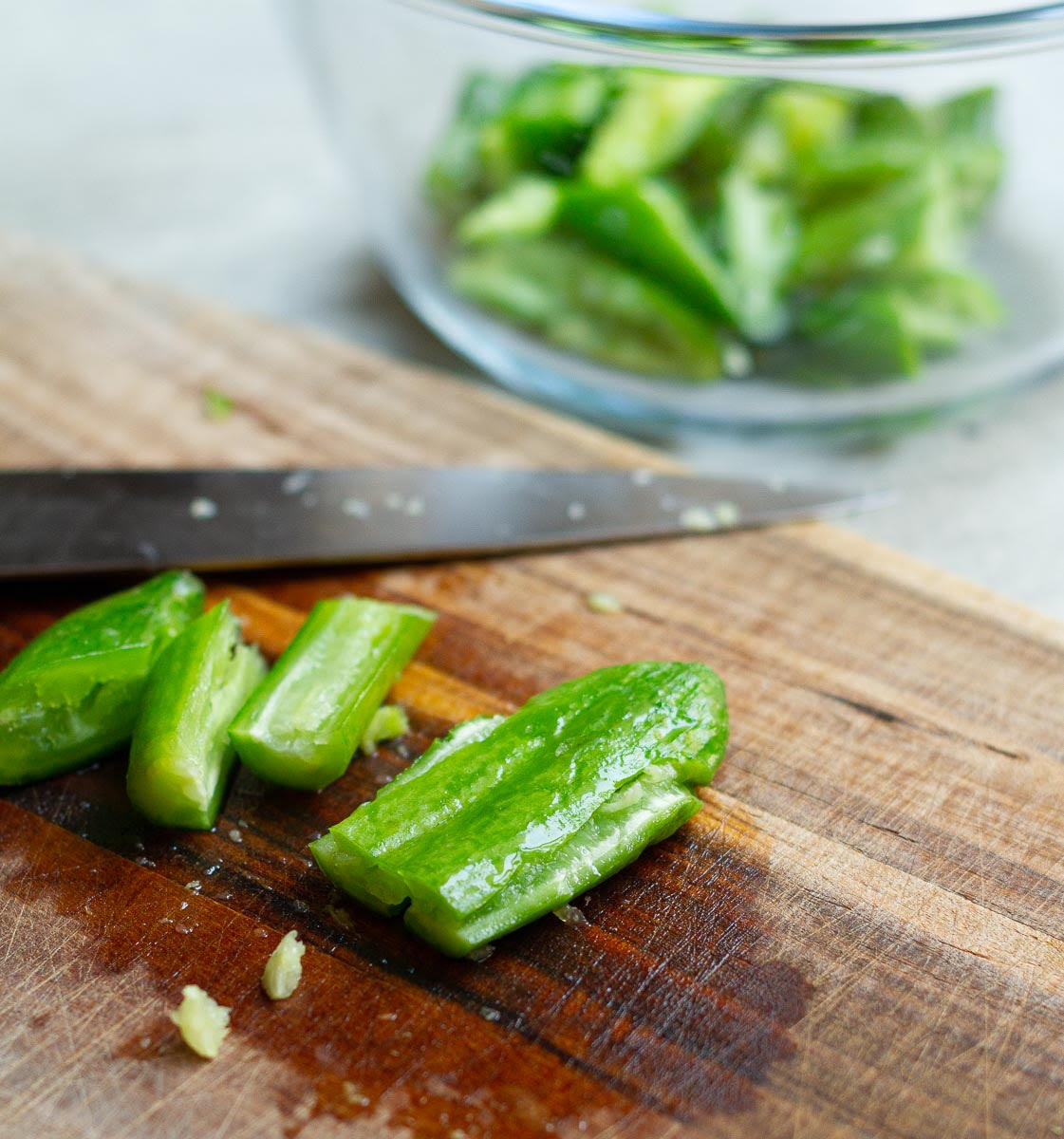 Smash the cucumbers using flat side of a large knife