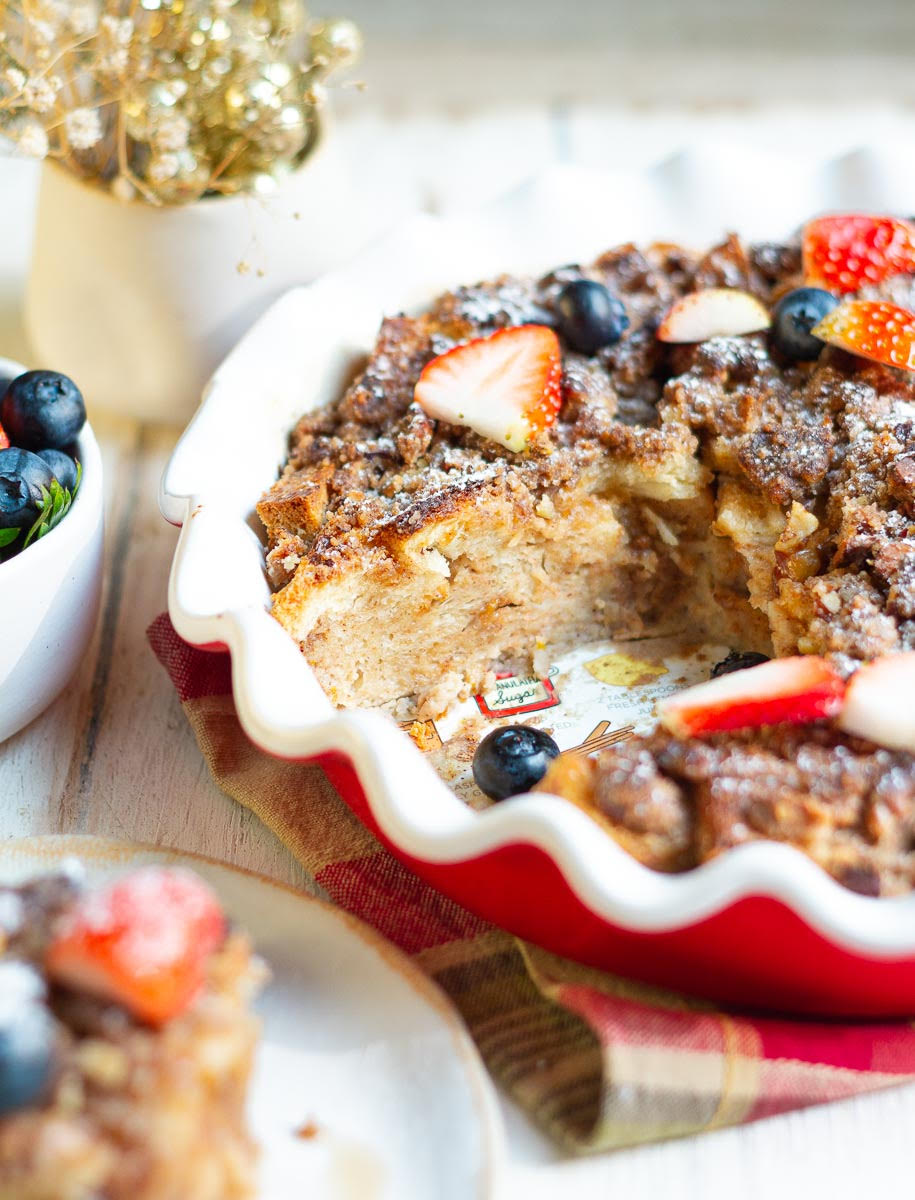 French toast casserole in a baking dish with one slice taken out.