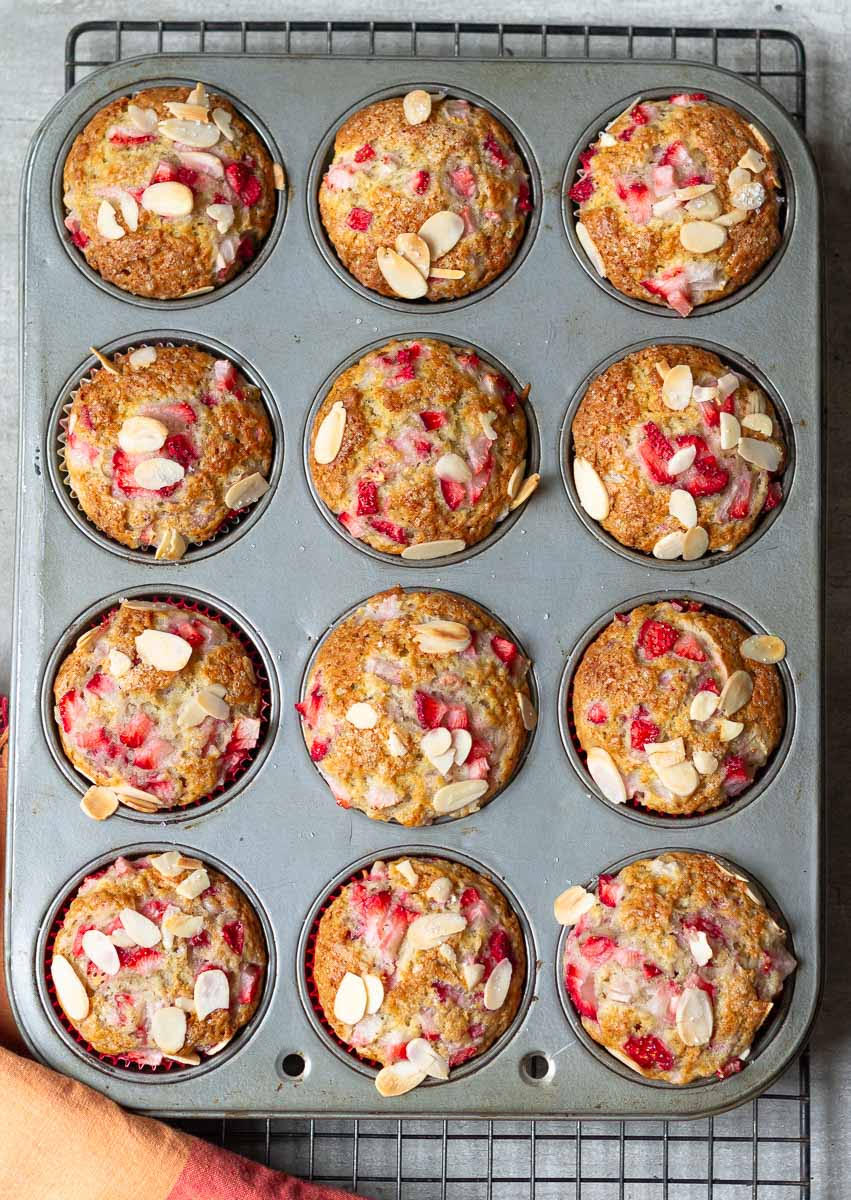 Baked Strawberry Banana Muffins in a muffin tray.
