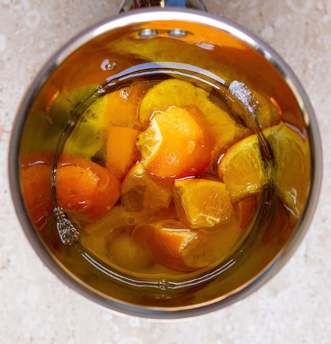 Oranges, eggs, oil, and vanilla extract in a blender jar.