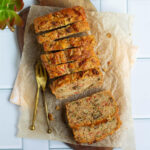 Carrot Zucchini Bread on parchment paper lined board with 2 forks.