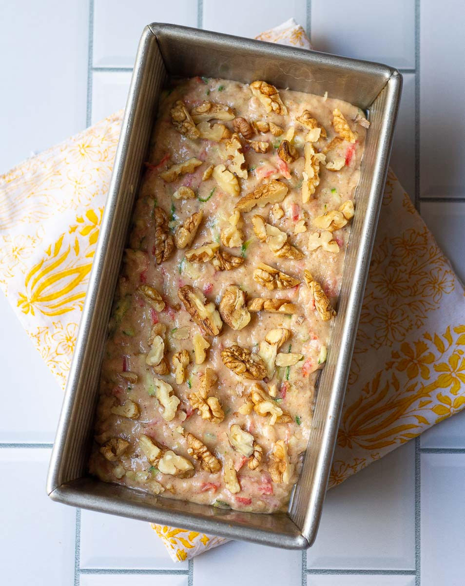 Cake batter in a metal loaf tin.
