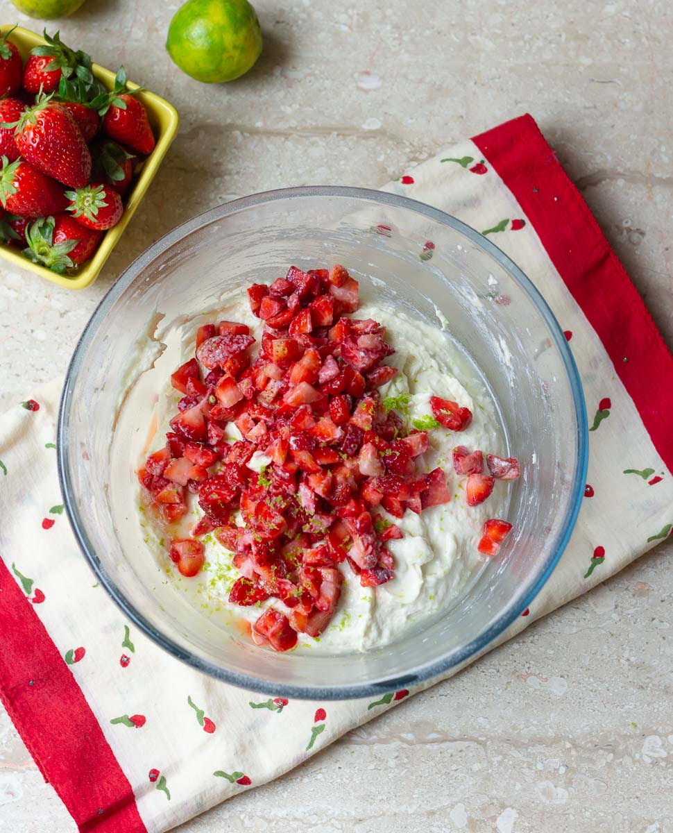 cake batter topped with chopped strawberries, lemon juice and lemon zest.