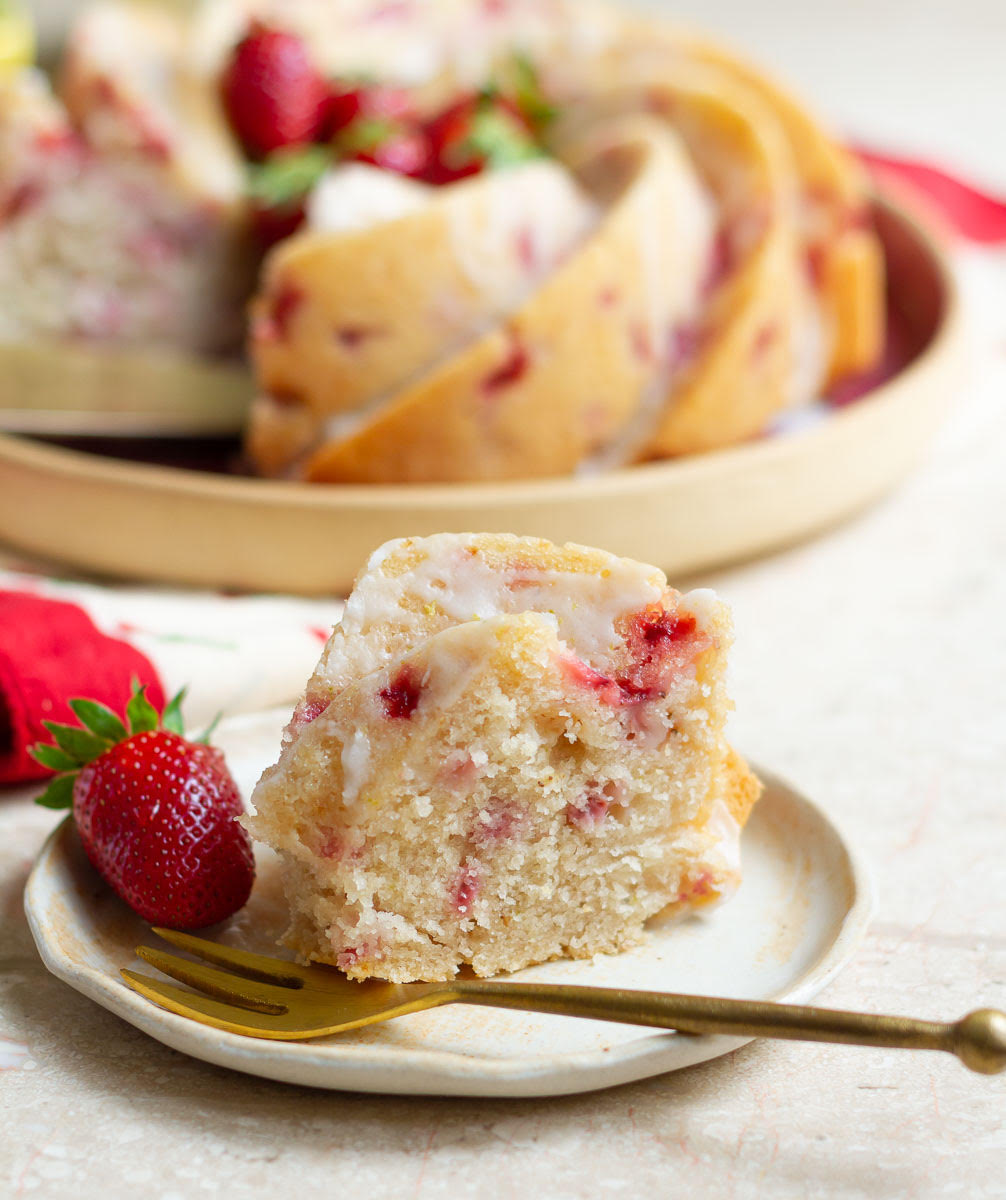 slice of Strawberry Lemon Bundt Cake on a small plate with a fork.