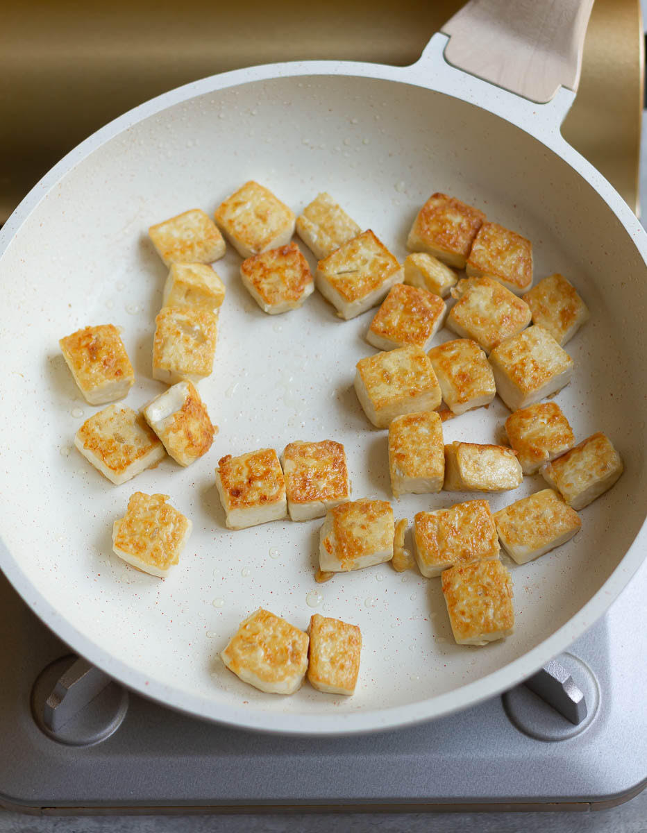Crispy pan-fried tofu in a skillet