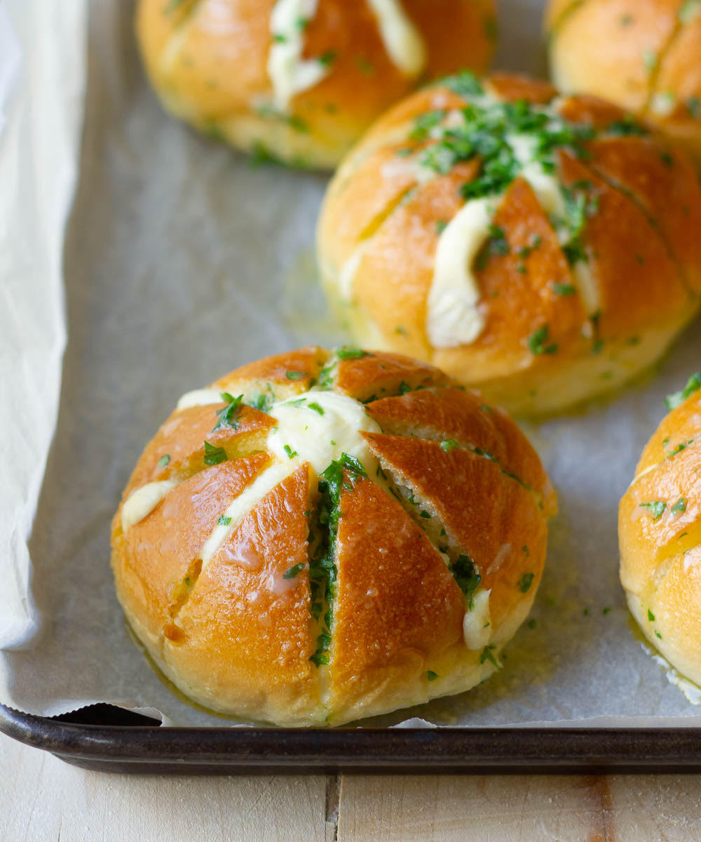 Rolls dunked in garlic butter mixture and placed on a baking tray