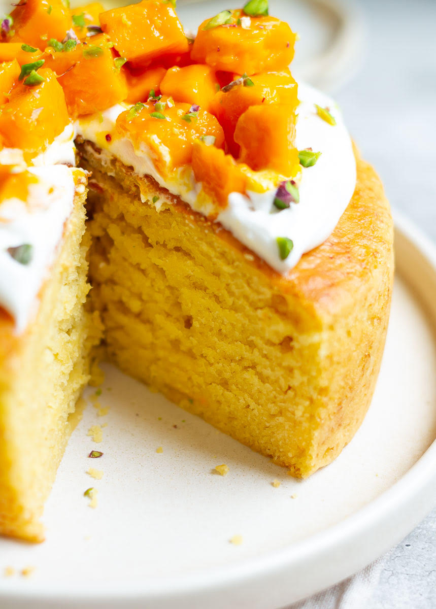 Mango cake with a slice taken out to show the texture.