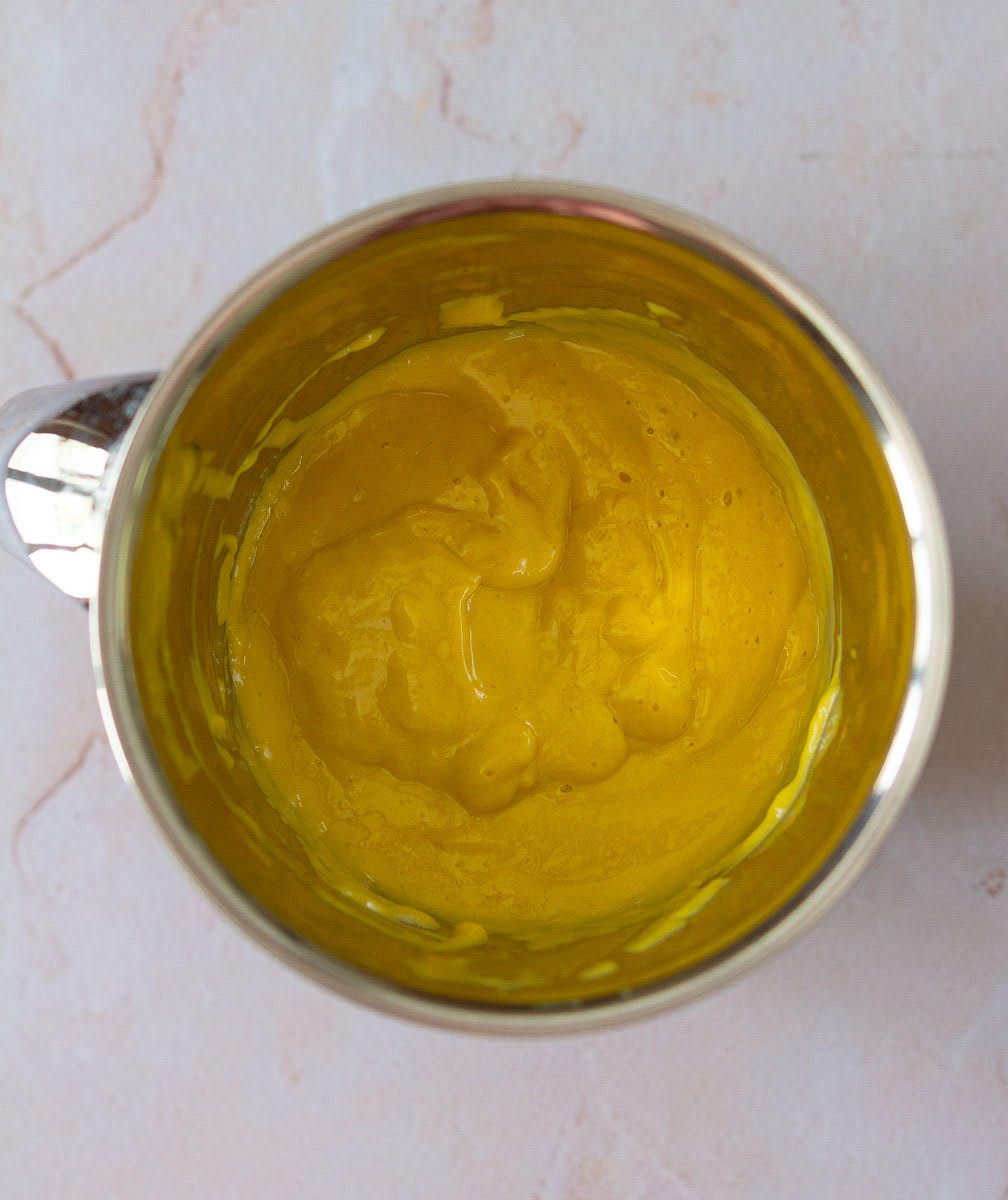 Mango, coconut milk, sugar blended in a blender jar.