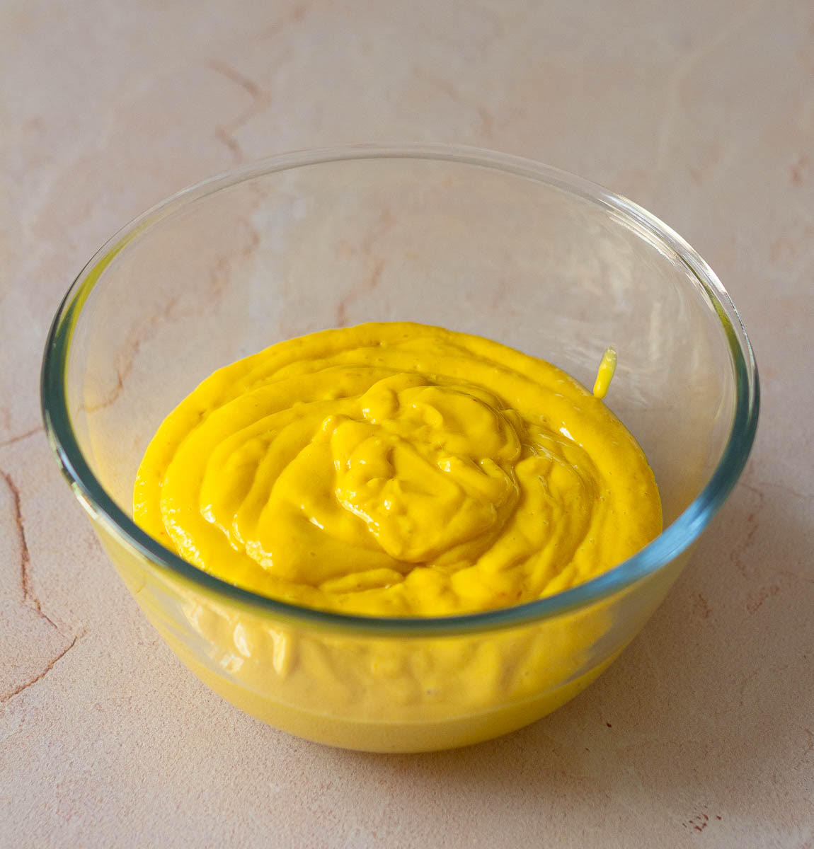 Blended mango, coconut milk, and sugar mixture in a bowl.