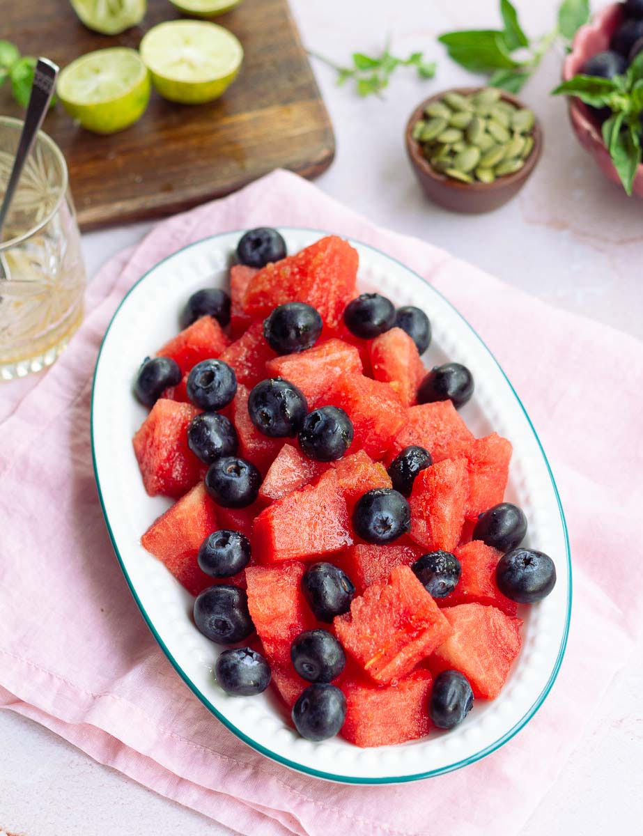 Pour the dressing over the watermelon and blueberries