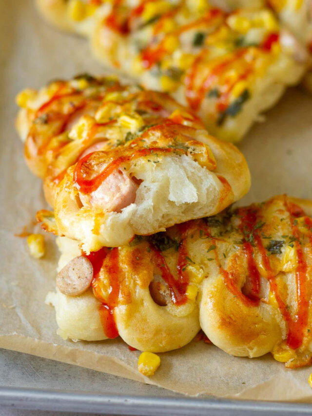 Half a sausage roll place on top of another one to show the cross section.