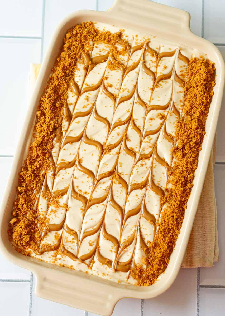 Biscoff icebox cake decorated with Biscoff swirls and Lotus cookie crumble