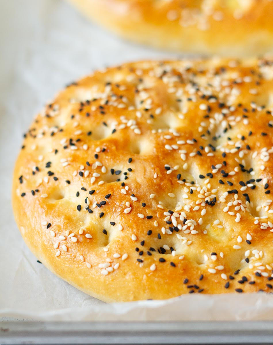 Baked Turkish pide bread with seeds on top.