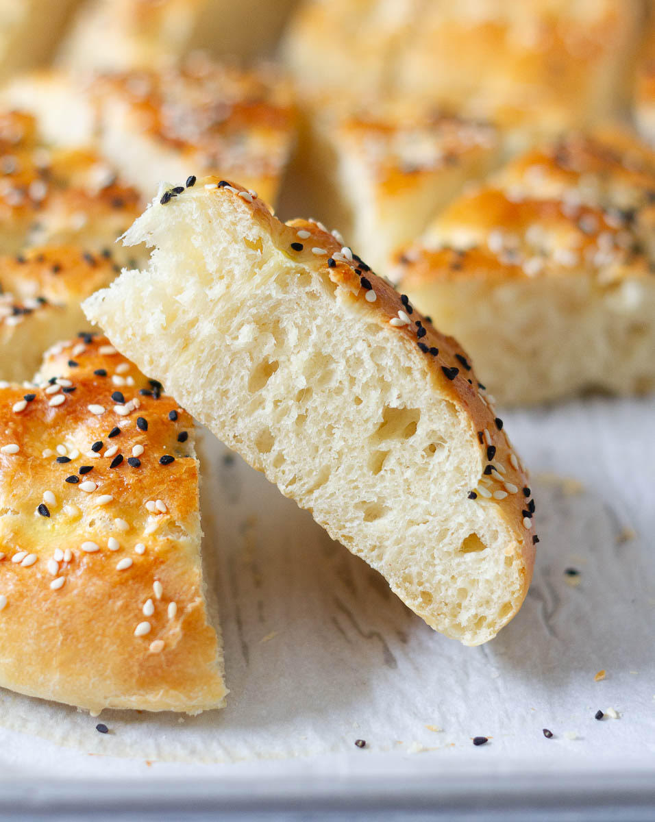 A slice of Turkish pide propped up on another slice.