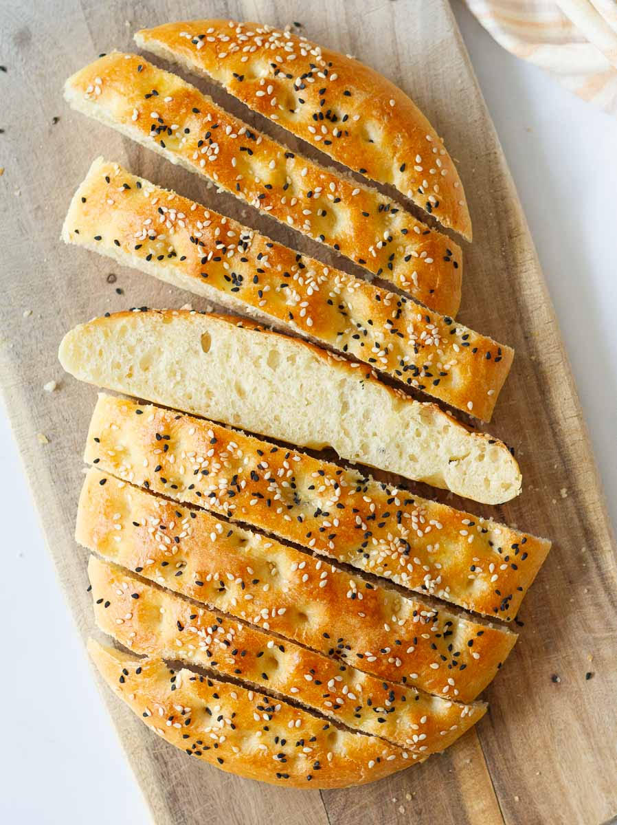 Sliced Turkish Pide on a wooden board.