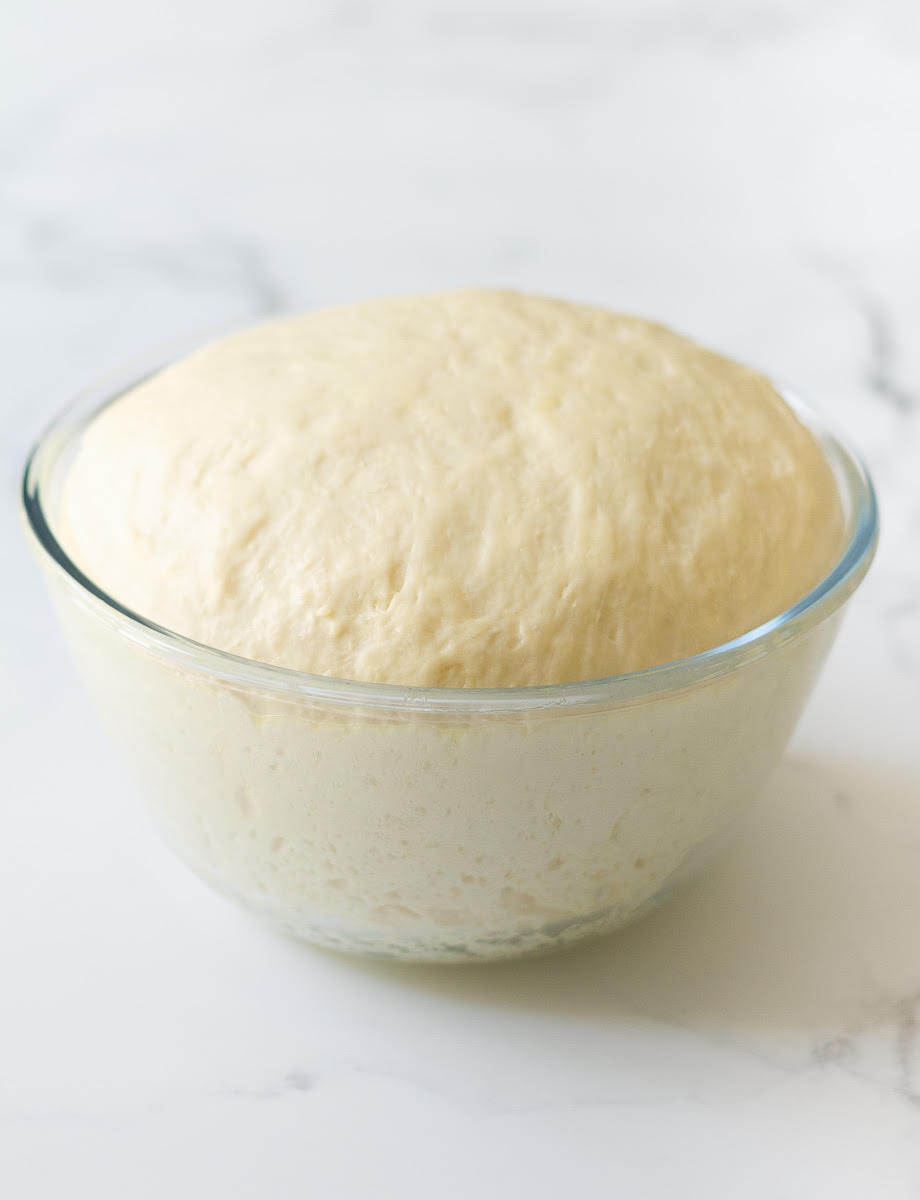 Proofed dough in a mixing bowl.