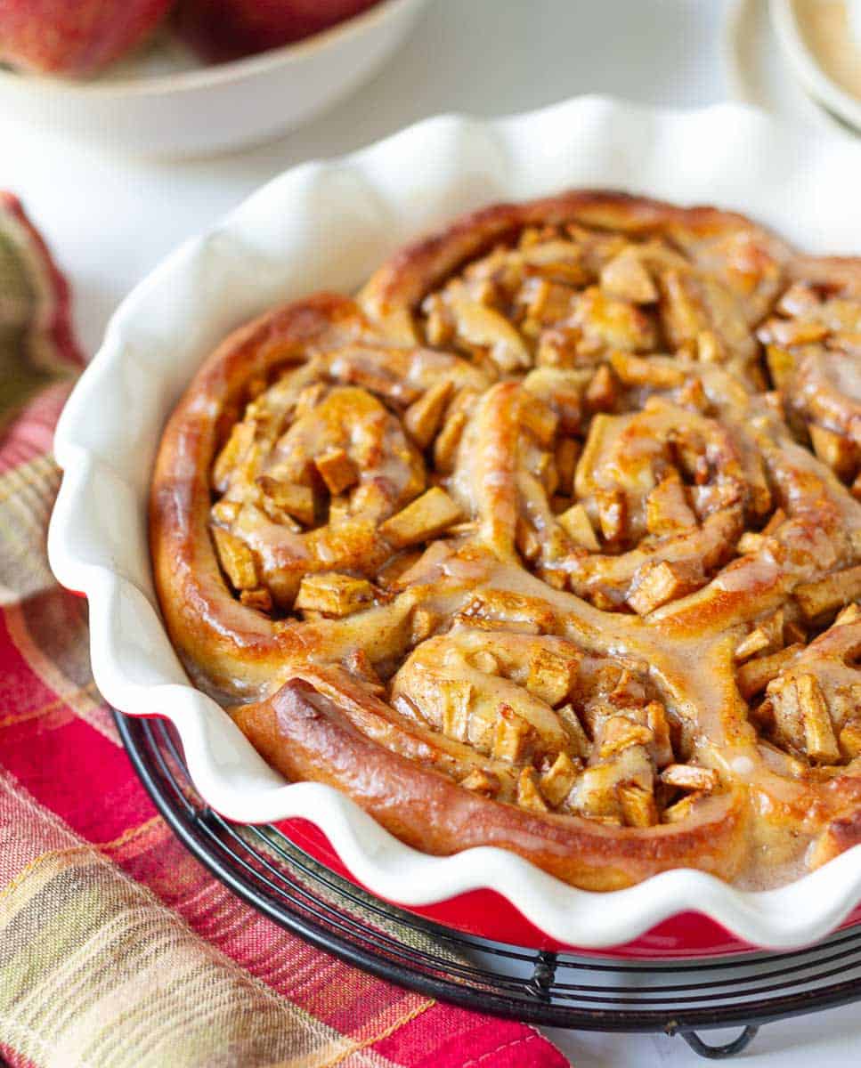 Apple Cinnamon Rolls in a round baking dish on a trivet.