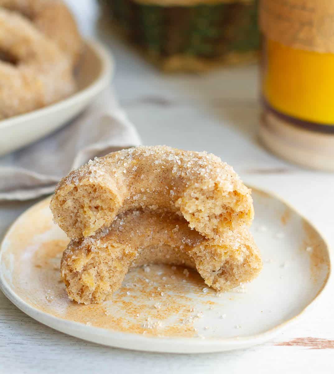 2 halves of an apple donut stacked on top of each other to show the fluffy texture.