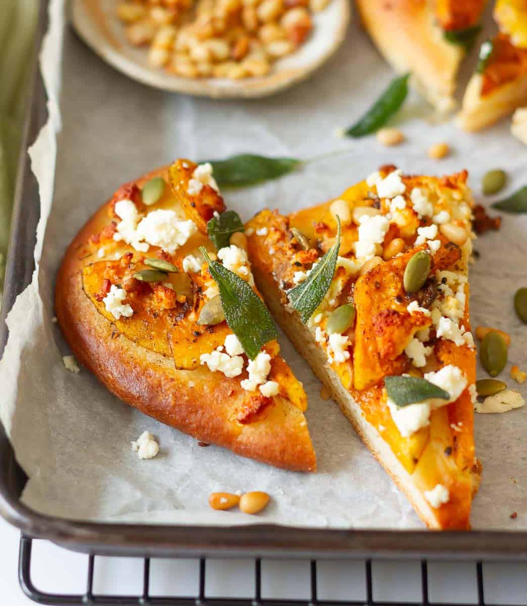 2 slices of butternut squash flatbread on parchment paper.