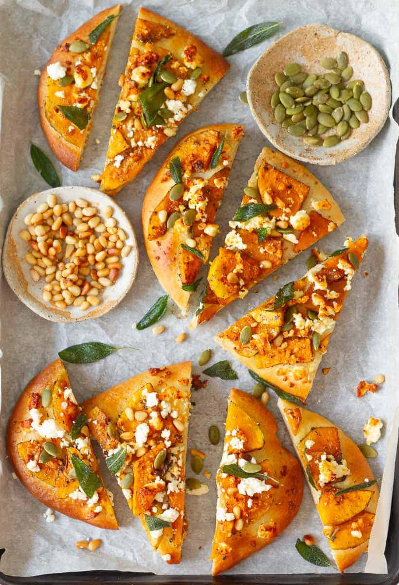 Sliced Butternut Squash Flatbread Pizza on parchment paper.