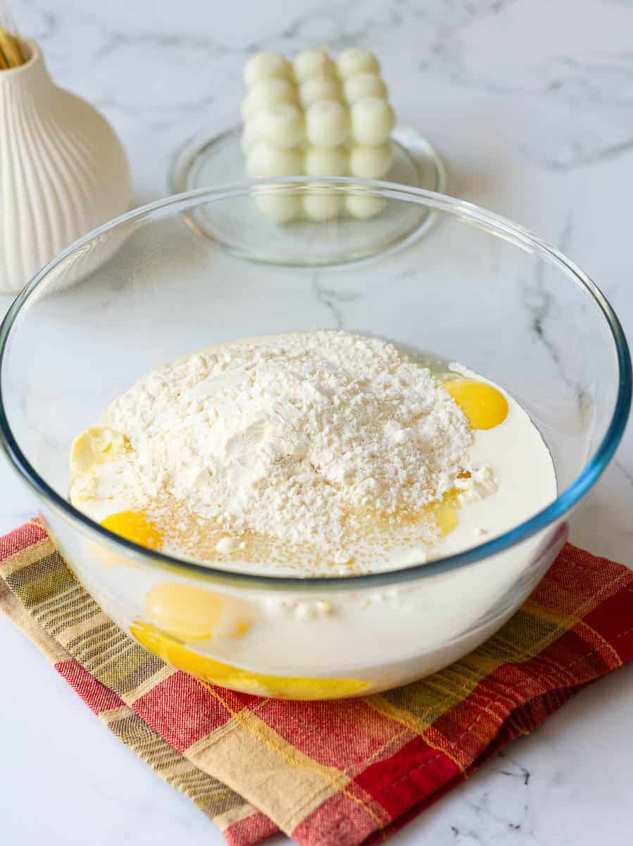 Ingredients for the cheesecake batter in a large bowl
